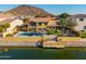 Backyard view of the home with a swimming pool, patio area, and waterfront dock at 21666 N 53Rd Dr, Glendale, AZ 85308