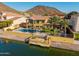 Backyard view of the home with a swimming pool, patio area, and waterfront dock at 21666 N 53Rd Dr, Glendale, AZ 85308