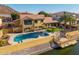 Backyard view of the home with a swimming pool, patio area, and waterfront dock at 21666 N 53Rd Dr, Glendale, AZ 85308