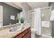 This bathroom has a wood vanity with granite countertops, providing a seamless blend of style and functionality at 21666 N 53Rd Dr, Glendale, AZ 85308