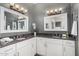 Elegant bathroom featuring dual sinks, granite countertops, and vanity lighting at 21666 N 53Rd Dr, Glendale, AZ 85308