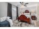 Bedroom with ceiling fan, wood floors, and a queen size bed at 21666 N 53Rd Dr, Glendale, AZ 85308