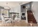 Inviting dining area with a modern chandelier and seating, steps away from the beautiful staircase with a comfortable atmosphere at 21666 N 53Rd Dr, Glendale, AZ 85308