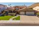 Charming home with a well-manicured lawn, three-car garage, and inviting facade in a desirable neighborhood at 21666 N 53Rd Dr, Glendale, AZ 85308