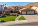 Inviting two-story home with well-manicured lawn, stone accents, and a spacious three-car garage at 21666 N 53Rd Dr, Glendale, AZ 85308