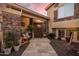 Charming front entrance featuring stone accents, decorative plants, and a cozy seating area at 21666 N 53Rd Dr, Glendale, AZ 85308