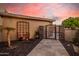 Welcoming walkway to a private gated entry with lovely landscaping, flowers, and a palm tree at 21666 N 53Rd Dr, Glendale, AZ 85308