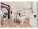 Bright kitchen features travertine floors, large island, a chandelier, and stainless steel appliances at 21666 N 53Rd Dr, Glendale, AZ 85308