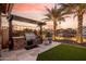 This outdoor kitchen features stone counters with a grill, enhancing outdoor living and entertaining at 21666 N 53Rd Dr, Glendale, AZ 85308