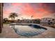 Stunning pool with waterfall feature and waterfront views at sunset at 21666 N 53Rd Dr, Glendale, AZ 85308