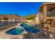 Outdoor swimming pool and spa with waterfall feature overlooking a tranquil waterfront and hillside scenery at 21666 N 53Rd Dr, Glendale, AZ 85308