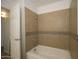 Bathroom features a shower and tub combo with tiled walls at 240 S Old Litchfield Rd # 206, Litchfield Park, AZ 85340