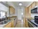 Galley kitchen features stainless steel appliances and granite countertops at 240 S Old Litchfield Rd # 206, Litchfield Park, AZ 85340