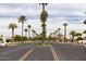 Street view featuring a long street, a center median and many palm trees at 240 S Old Litchfield Rd # 206, Litchfield Park, AZ 85340