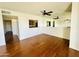 Bright living room with wood floors, view into the kitchen and expansive mirrored wall at 240 S Old Litchfield Rd # 208, Litchfield Park, AZ 85340