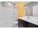 Well-lit bathroom featuring a shower-tub combo with modern fixtures and a dark vanity at 2466 E Rosario Mission Dr, Casa Grande, AZ 85194