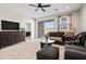 Cozy living room with tiled floors, a ceiling fan, and a sliding glass door leading to the outdoor space at 2466 E Rosario Mission Dr, Casa Grande, AZ 85194