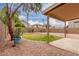 Backyard featuring grass, gravel, a covered patio, a block wall, and desert landscaping at 2551 E Kent Ave, Gilbert, AZ 85296