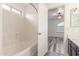 Bathroom with tiled shower, tub, white vanity, and view of the main bedroom at 2551 E Kent Ave, Gilbert, AZ 85296