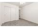 A bedroom with gray carpeting, a ceiling fan, a closet, and a connecting door at 2551 E Kent Ave, Gilbert, AZ 85296