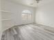 Bedroom featuring wood-look floors, ceiling fan, a large window, and neutral paint at 2551 E Kent Ave, Gilbert, AZ 85296