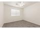 A bedroom with gray carpeting, a ceiling fan and a window with adjustable white blinds at 2551 E Kent Ave, Gilbert, AZ 85296