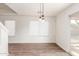 Bright dining area with wood-look floors, modern lighting, and a sliding glass door at 2551 E Kent Ave, Gilbert, AZ 85296