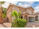 Front exterior view of the two-story home with desert landscaping and a two-car garage at 2551 E Kent Ave, Gilbert, AZ 85296