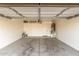 An empty two-car garage with a water heater, overhead storage, and a white back door at 2551 E Kent Ave, Gilbert, AZ 85296