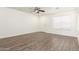 Bright living room with wood-look floors, a ceiling fan, and a front door at 2551 E Kent Ave, Gilbert, AZ 85296