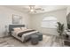 Serene main bedroom showcasing a plush bed, accent furniture, and a large arched window at 2551 E Kent Ave, Gilbert, AZ 85296