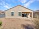 A well-maintained backyard featuring a covered patio and easy-care gravel landscaping at 25601 W Coles Rd, Buckeye, AZ 85326