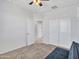 Clean bedroom featuring neutral carpet, a ceiling fan, and double door closet for storage at 25601 W Coles Rd, Buckeye, AZ 85326