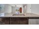 Open-concept kitchen showcases a granite-topped island with a stainless steel sink at 25601 W Coles Rd, Buckeye, AZ 85326