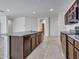 Modern kitchen island with granite counters overlooks the living area in an open layout at 25601 W Coles Rd, Buckeye, AZ 85326