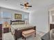 The main bedroom features carpeted floors, neutral-tone walls, a ceiling fan, and natural light from two windows at 25601 W Coles Rd, Buckeye, AZ 85326