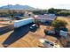 An aerial shot of a rural property including a pool, multiple structures, and a large dirt lot at 26631 S Lime Dr, Queen Creek, AZ 85142