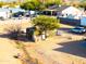 Backyard view featuring a chicken coop, a dry creek bed, and a large dirt lot at 26631 S Lime Dr, Queen Creek, AZ 85142