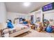 Spacious bedroom featuring neutral walls, carpet, and a TV screen. Storage areas can be found throughout at 26631 S Lime Dr, Queen Creek, AZ 85142