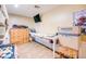 Bedroom featuring a bunk bed, a long table, and a small dresser. An attached TV at 26631 S Lime Dr, Queen Creek, AZ 85142