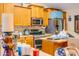 Galley kitchen featuring wood cabinets, stainless steel appliances, and a neutral countertop at 26631 S Lime Dr, Queen Creek, AZ 85142