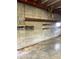 Spacious garage interior featuring gray concrete block walls, concrete flooring and high ceilings at 2721 W Rose Ln, Phoenix, AZ 85017