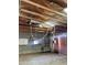 Exposed overhead structure and hoist system add an industrial feel to this large garage space at 2721 W Rose Ln, Phoenix, AZ 85017