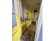 A view into a yellow kitchen featuring wood floors and laminate countertops at 2721 W Rose Ln, Phoenix, AZ 85017