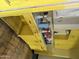 Retro yellow kitchen featuring vintage cabinets and countertop, waiting for a modern touch at 2721 W Rose Ln, Phoenix, AZ 85017