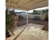 Charming backyard patio with a covered area, tiled flooring, desert landscaping, and a blossoming bougainvillea at 2837 W Angela Dr, Phoenix, AZ 85053