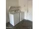 Functional laundry area featuring a washer and dryer with overhead shelving at 2837 W Angela Dr, Phoenix, AZ 85053