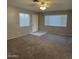 Cozy living room with new carpeting, neutral colored walls, and multiple windows that provide ample natural light at 2837 W Angela Dr, Phoenix, AZ 85053