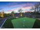 Private putting green with desert views at dusk at 29348 N Clear Ridge Rd, Rio Verde, AZ 85263