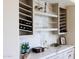 Contemporary bar area with marble backsplash, wine rack, shelving, and beverage refrigerator at 29348 N Clear Ridge Rd, Rio Verde, AZ 85263